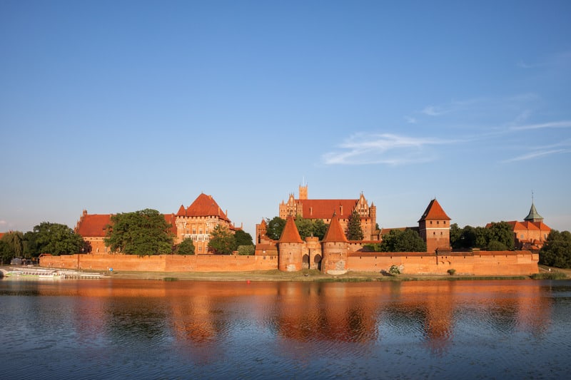 view of the Malbork Castle by the Nogat River in Poland