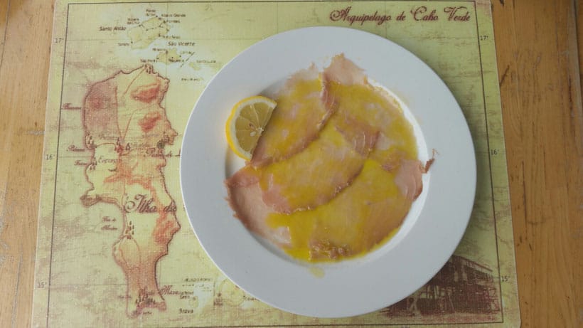 Take part in these sal activities this summer, plate of tuna carpaccio sitting on a placemat with old style map drawings on a wooden table