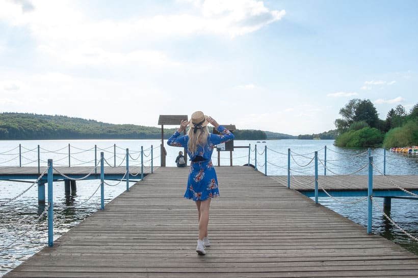 a woman on a dock at kashubia switzerland lake