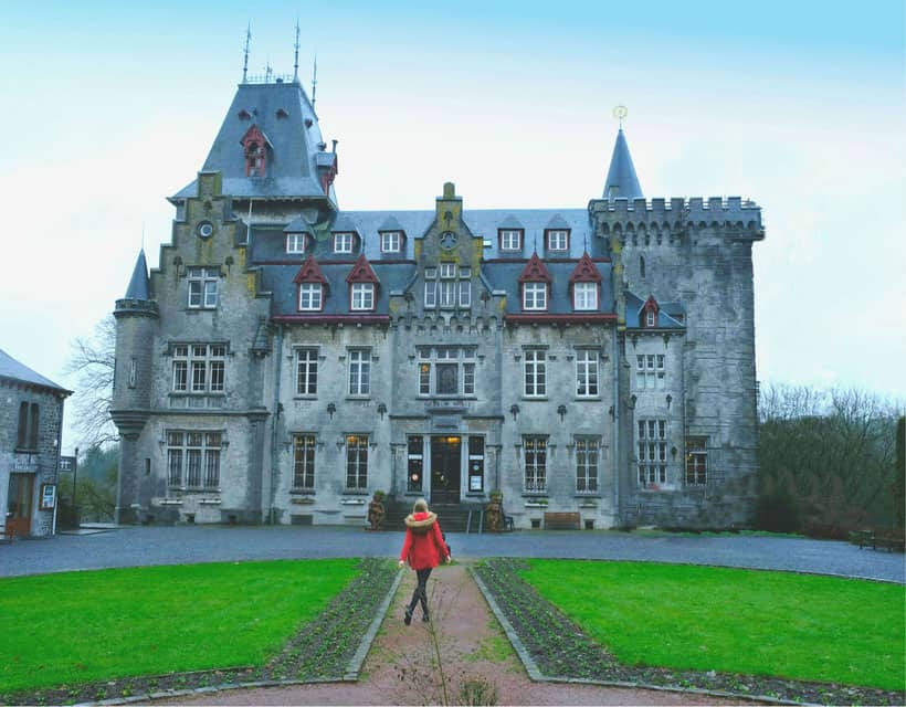 radadesh durbuy things to do, a woman in red in a walkway leading to castle manor