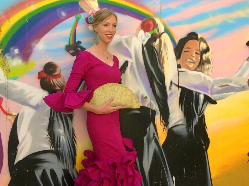 feria, travel blogger spain, a woman posing on a painted mural 