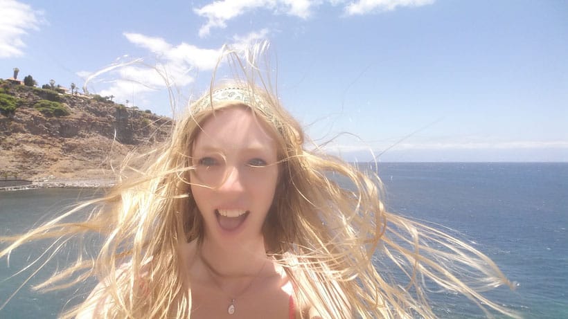 a woman taking a selfie with a beach at the back, gomera-tenerife-ferry-canarias-canary-islands-hiking-senderismo-capital-food-comida-spain-espana-island-silbo-gomerano-paradise-nature-naturaleza-car-coche-san-sebastian-gofio-teide-colon-columbus.jpg