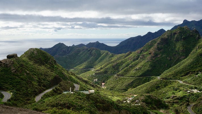 where to go in north tenerife, road cutting through the mountains with ocean in background