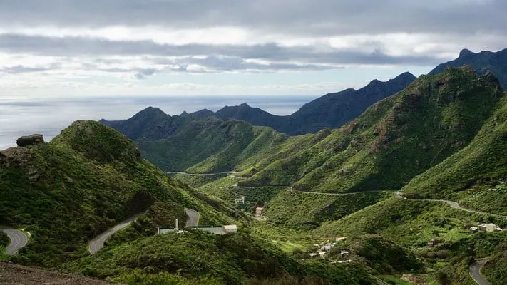 where to go in north tenerife, road cutting through the mountains with ocean in background