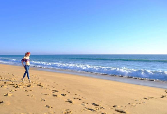 winter in the algarve, walking along the sandy beach