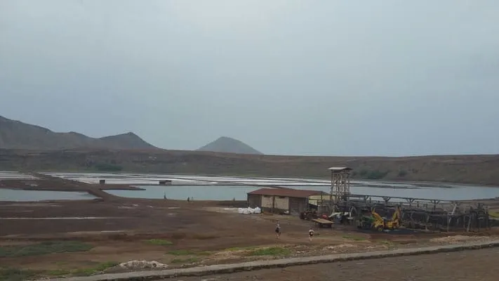 Discover all the great things to do in sal cape verde, buildings and equipment in a wide open area with planned sections of land and mountains in the distance under a grey sky