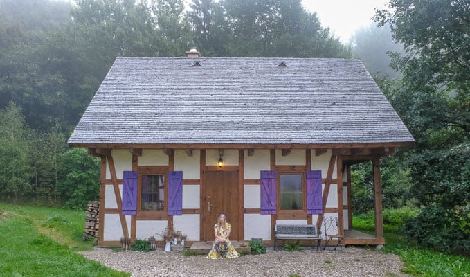 a woman sitting by the door at a farmhouse at lavender farm