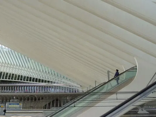 what to see in liege, a woman coming down the escalator in liege train station