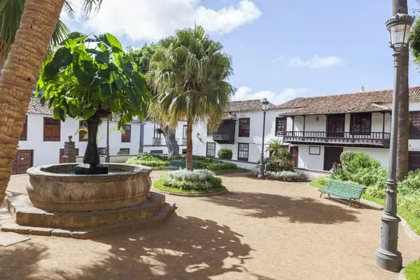 things to do in tenerife for free, outdoor seating area with trees and fountain