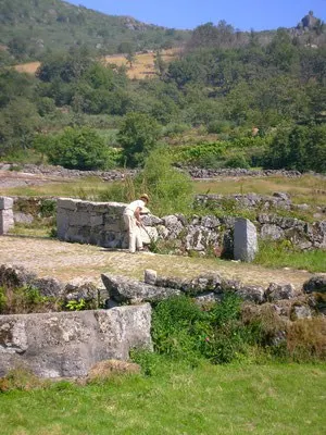 best places in north portugal, person looking at stone ruins in a rural area