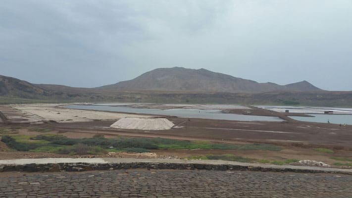 Find all the great things to see in sal cape verde, wide open area with planned sections of land and mountains in the distance under a grey sky