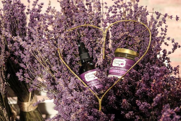 2 products in a bottle surrounded by heart-shaped lavender