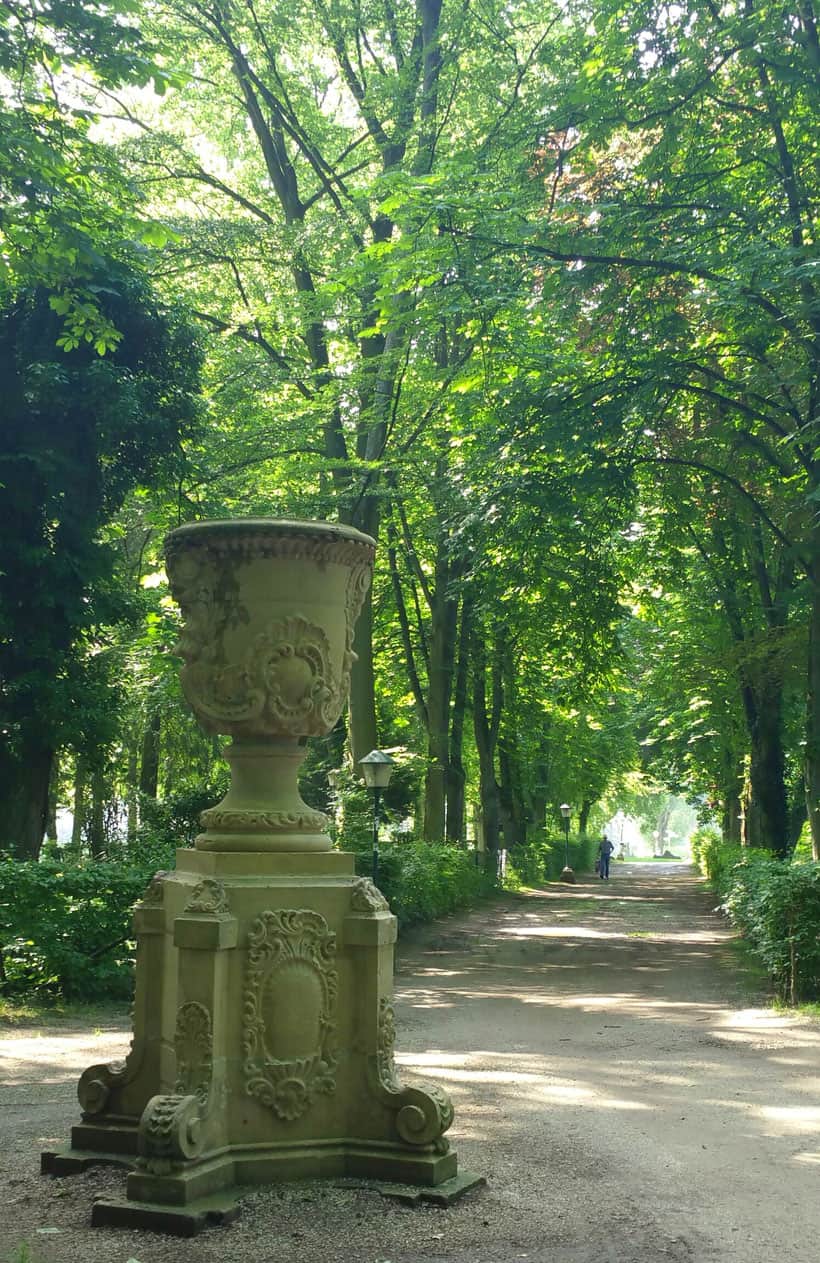 walking in the park of echternach with green leaves and benedictine details