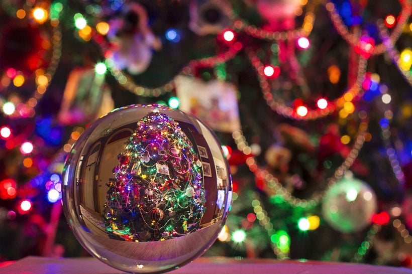 Christmas ball reflecting a christmas tree with christmas lights, Best wisconsin christmas market, View of Christmass tree reflected in round silver ornament