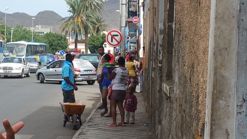 streets of mindelo, sao vicente island cape verde with people on the sidewalk and cars