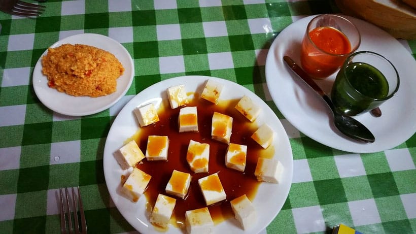 Discover the answer to the question what is Tenerife known for, plates of food sitting on top of green and white chequered tablecloth