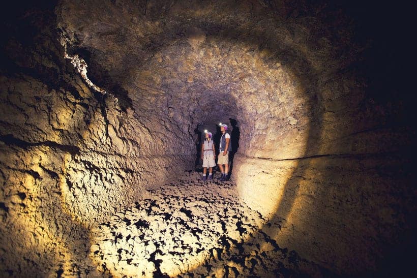 what to see and do in tenerife, two people walking through cave of the winds.
