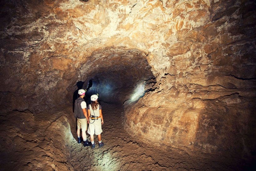 cool things to do in north tenerife, two people inside of a cave