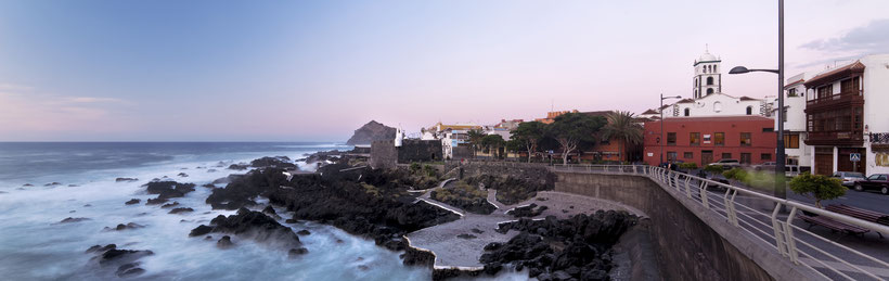 north vs south tenerife, view of coast and coastal town and waves crashing against the rocks