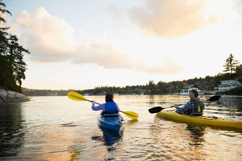 people kayaking on a sunset