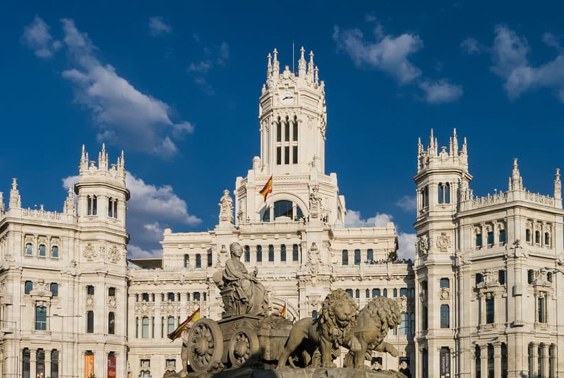 best neighborhoods to stay in Madrid, exterior view of Cybele Palace with statue of woman being pulled by lions