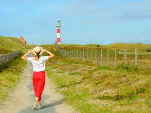 travel partner, guest post, sponosred post, outdoor gear, hiking, outdoor, UK audience, US audience, a woman in white shirt and red pants looking at a light tower