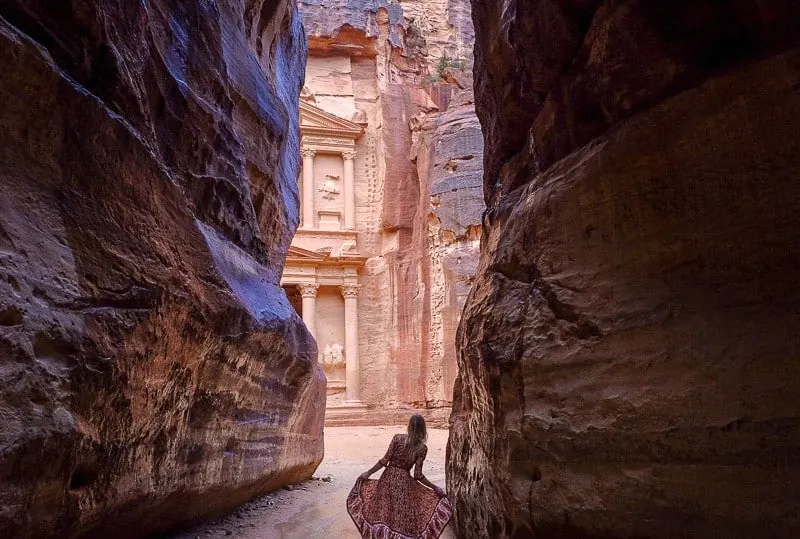 jordan 10 day itinerary, what to do in jordan, things to do in jordan, petra, aqaba, jordan hotels amman, jerash, dead sea, spa, luxury hotels, wadi rum, diving, hiking, treasury, a woman looking up exploring between large rocks