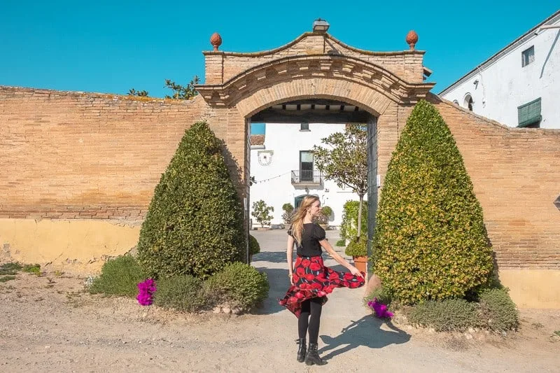 wine tour barcelona, wineries near barcelona, Cava Tasting in Ca N’Estella. clot dels oms, champagne tasting, catalonia, twirling blond girl entrance door