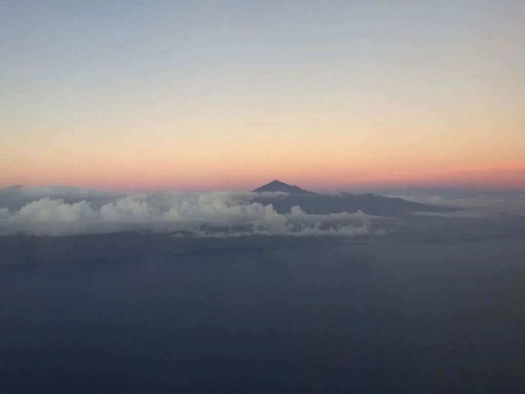 How to get to the Mount Teide hike, sunset view of Mount Teide in distance surrounded by clouds