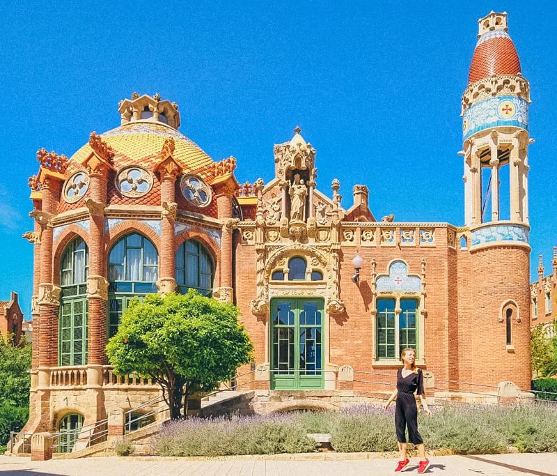 a woman wearing a black jumpsuit posing at barcelona hospital sant pau