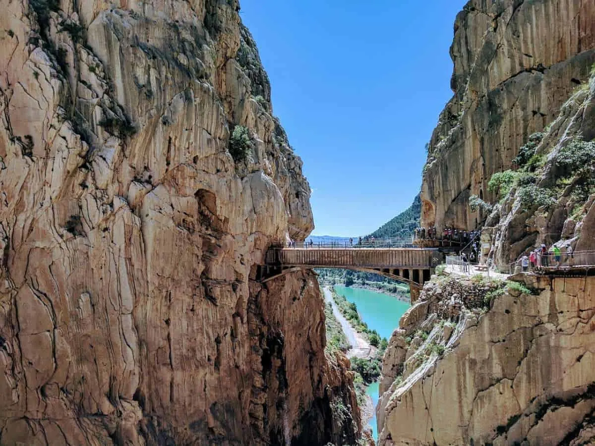 best winter family holidays in spain, people walking across the caminito del rey bridge