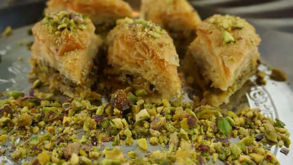 a closeup of pistachio baklava, things to do in aqaba, jordan, red sea, wadi rum day trip, petra day tour, resorts, ayla oasis, souk, shopping, egypt, beaches, luxury