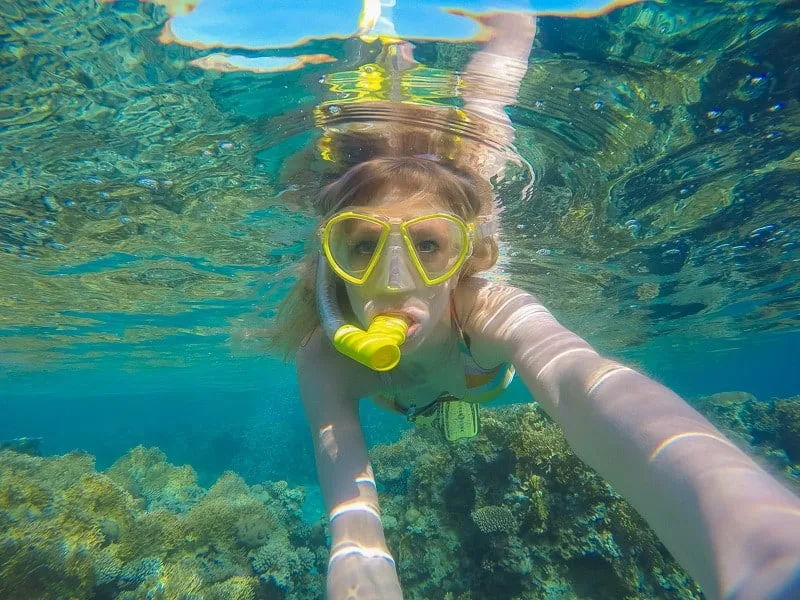 Breathtaking activities in Tenerife, scuba diving in clear blue waters with yellow snorkel