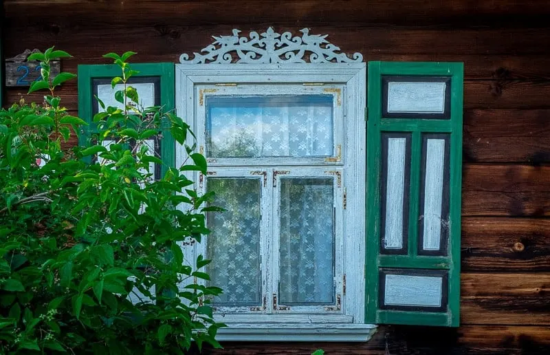 Visit Bialowieza Poland, colourful wooden window shutters
