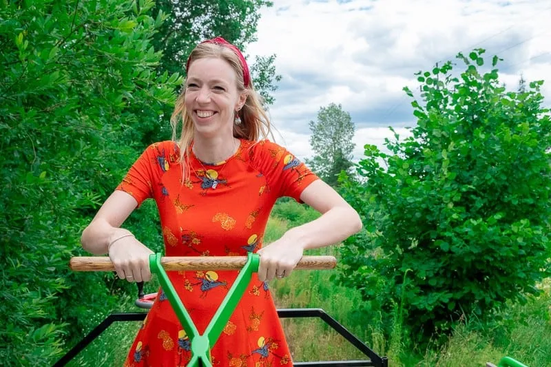 hand ride train in bialowieza, activities in bialowieza, things to do, a woman smiling happily riding a bike with trees on the background