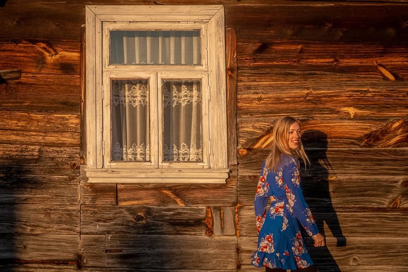 girl dancing in front of an old house in podlaskie, poland