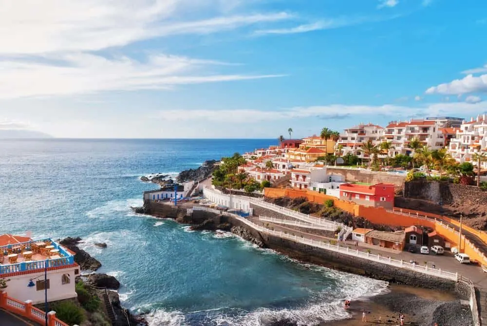 a colorful town bu the beach, best beaches in tenerife, volcanic sand beach, golden sand beach, las teresitas beach, costa adeje beach, scenic beach, secluded beach in tenerife, canary islands, los gigantes