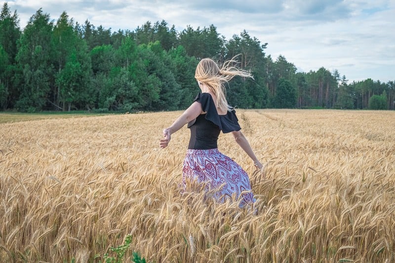 girl dancing in the wheat fields in poland