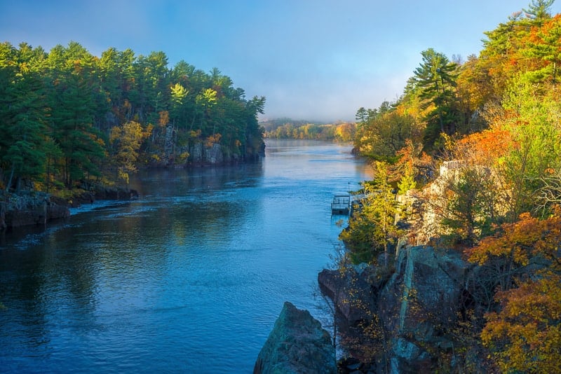 clearing morning fog on the st. croix river in interstate state park, minnesota during autumn.