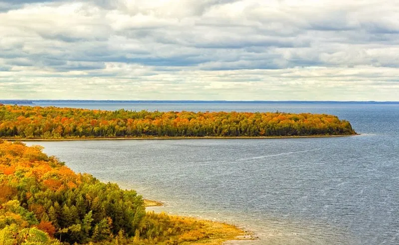 best fall places to visit in wisconsin, peninsula in Door County during fall covered in fall foliage