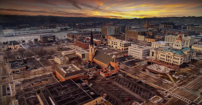 where to go during winter in Wisconsin, aerial view of green bay Wisconsin at sunset with many buildings and streets covered in light dusting of snow