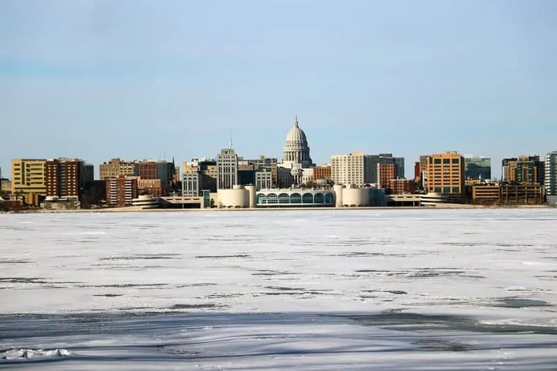 Madison winter cityscape with frozen lake Monona on a foreground during cold sunny day. Midwest USA, Wisconsin.