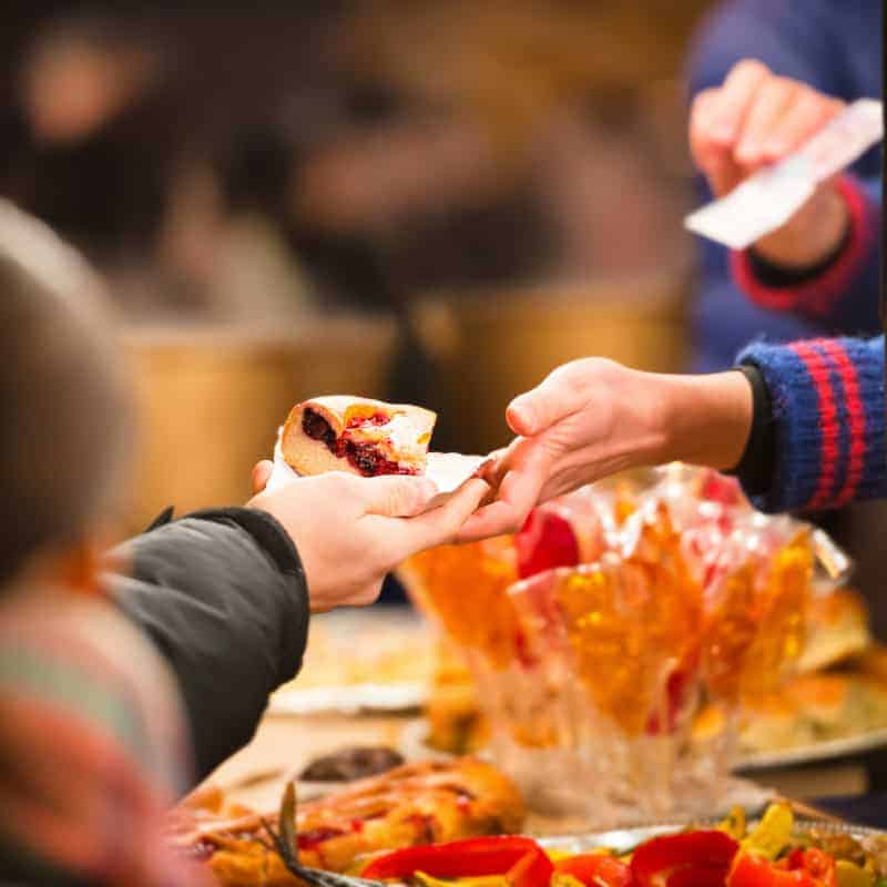best fall things to do in Wisconsin, Hands holding piece of apple pie at the Apple Harvest Festival in Wisconsin