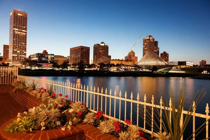 best bike trails in Milwaukee, view of Milwaukee skyline lit up at night, just after sunset