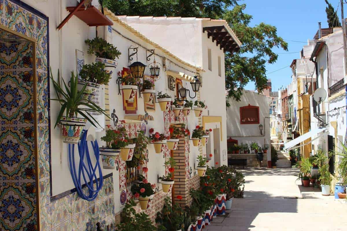 cheap winter breaks spain, street in costa blanca lined with flowerpots and plants