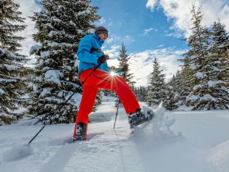 best winter activities to do in Lake Geneva, man snowshoeing in the winter