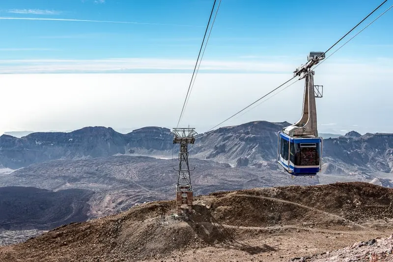 A cable car ascending Mount Teide On the island of Tenerife, with the old lava flows visible below.