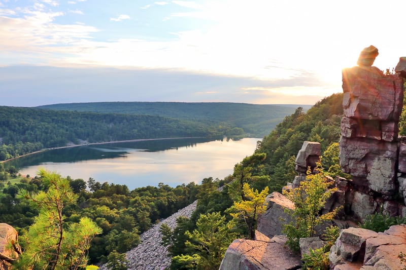 things to do in Wisconsin in fall, Aerial view on the South shore beach and lake from rocky ice age hiking trail during sunset. Devil's Doorway location.