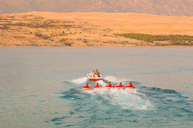 Kids tube riding tawed by speedboat on Croatian coast. Summer sea fun and adventure. Exciting water sport. tenerife, spain, watersports
