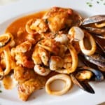 Fresh fried spicy seafood plate mixed diablitos style served in local restaurant in algarve